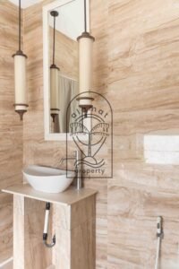 Bathroom with freestanding tub and stone-tiled walls at Villa Hingga