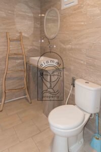 Bathroom with freestanding tub and stone-tiled walls at Villa Hingga
