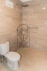 Bathroom with freestanding tub and stone-tiled walls at Villa Hingga