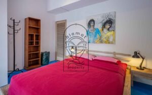 Villa Kaleidoscope bedroom with pink bedding and colorful artwork, Seminyak