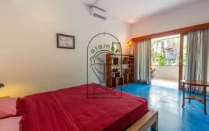 Villa Kaleidoscope bedroom with blue floor and garden-facing balcony, Seminyak