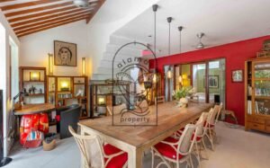 Villa Kaleidoscope open-plan dining and living room with red accent wall, Seminyak
