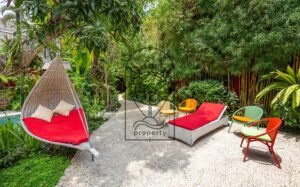 Villa Kaleidoscope tropical garden with hanging daybed and bamboo fence, Seminyak