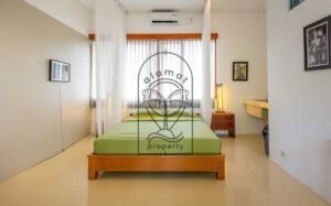 Villa Kaleidoscope bedroom with green bedding and sheer curtains, Seminyak