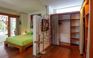 Villa Kaleidoscope bedroom with open wardrobe and colorful artwork, Seminyak