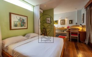 Villa Kaleidoscope bedroom with green wall and framed artwork, Seminyak