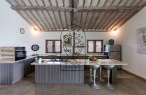 Villa Pachy modern kitchen with island, gas hob and bar stools