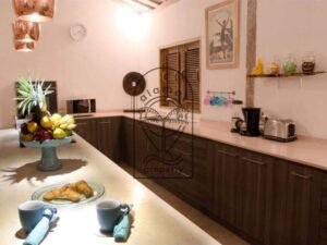 Villa Pachy kitchen with wooden cabinets and fruit bowl