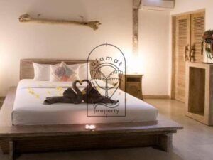 Villa Pachy bedroom with towel swans and frangipani flowers on the bed