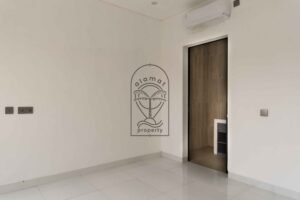 Bright white bedroom with ensuite bathroom in Villa Fenja