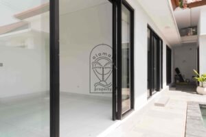 Bright white bedroom with ensuite bathroom in Villa Fenja