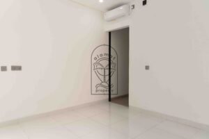 Bright white bedroom with ensuite bathroom in Villa Fenja