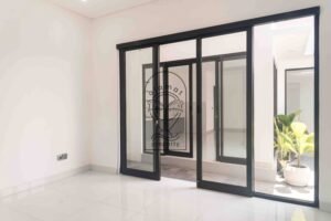 Bright white bedroom with ensuite bathroom in Villa Fenja