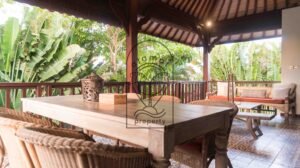Covered outdoor dining pavilion surrounded by greenery at Villa Bugenvil