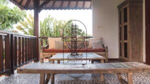 Upper-level terrace lounge with daybed and garden view at Villa Bugenvil