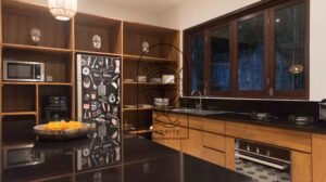 Kitchen with dark countertops and traditional mask decor at Villa Bugenvil