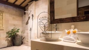 Outdoor bathroom vanity with stone counter and rain shower at Villa Bugenvil