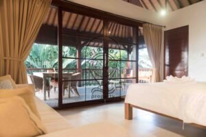 Bedroom opening onto covered terrace dining area at Villa Bugenvil