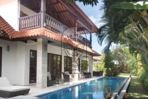 Two-story villa exterior with pool and tropical garden at Villa Bugenvil