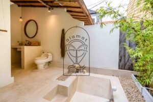 Tropical bathroom with bathtub in Bali villa