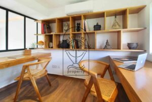 Villa Melati home office nook with built-in shelving and rattan chairs, Berawa Bali