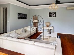 Home cinema lounge with projector screen and cozy sofas at Villa Kemuning
