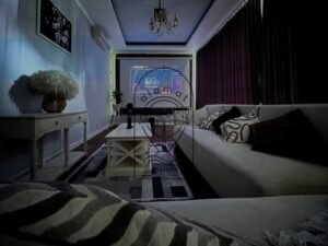 Home cinema lounge with projector screen and cozy sofas at Villa Kemuning
