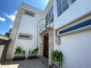 Modern Balinese villa entrance with carved wooden door