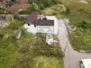 Freehold land for sale in Kedungu with plot boundary outlined in red beside a rooftop