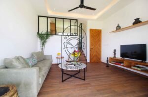 Villa Melati living room with grey sofa and TV console, Berawa Bali