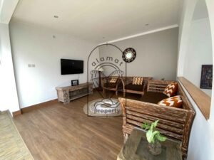 Open living area with sofas and Balinese-style decor at Villa Ramaia