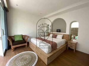 Bright bedroom with rustic wood bed at Villa Ramaia
