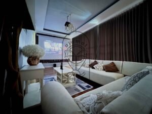 Home cinema lounge with projector screen and cozy sofas at Villa Kemuning