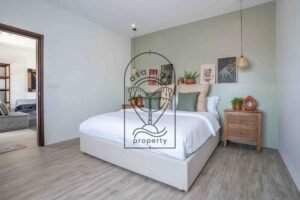 Bedroom with gallery wall and pendant lighting at Villa Aruna Sari