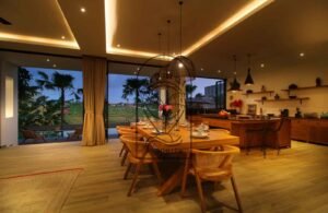 Villa Melati open-plan kitchen and dining room at night, Berawa Bali