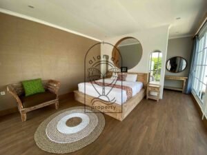 Bright bedroom with rustic wood bed at Villa Ramaia
