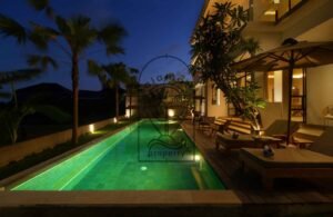 Villa Melati swimming pool at night with palm trees, Berawa Bali
