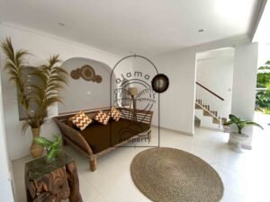 Open lounge with daybed opening onto the pool deck at Villa Ramaia