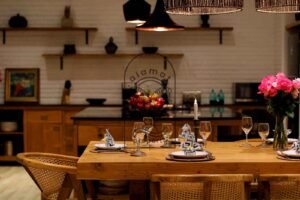 Villa Melati dining table set with wine glasses and roses, Berawa Bali