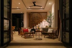 Villa Melati lounge area at night with wooden staircase, Berawa Bali