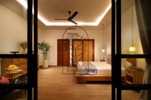 Villa Melati bedroom at night with wooden bed frame, Berawa Bali