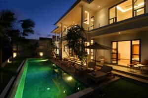 Villa Melati exterior at dusk with illuminated swimming pool, Berawa Bali