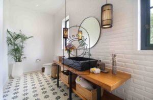Villa Melati en-suite bathroom with black stone sink and round mirror, Berawa Bali