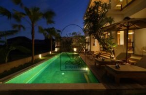 Villa Melati long swimming pool illuminated at night, Berawa Bali