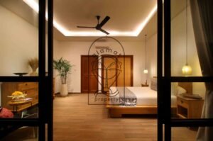 Villa Melati bedroom at night with wooden doors and rattan closet, Berawa Bali