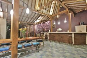 Villa Mizu dining table, bar stools and high joglo roof