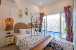 Bedroom with floral wallpaper and glass doors facing the pool at Villa Jendaya