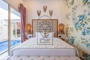 Bedroom with rattan lamps and view on the pool