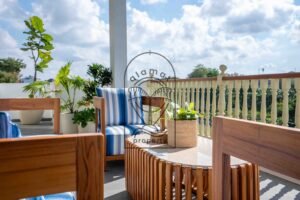 Teak coffee table and striped armchairs on the upper terrace at Villa Jendari